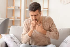 Coughing,Young,Man,At,Home